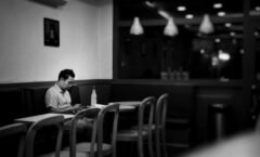 man sits alone in a diner